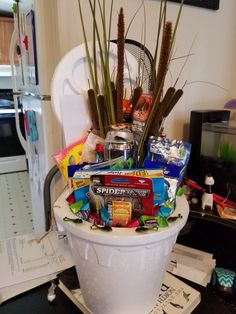 a white bucket filled with lots of candy and candies on top of a counter