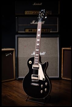 an electric guitar sitting on top of a wooden floor