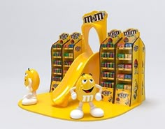 a yellow play set with an inflatable slider and two toy figurines