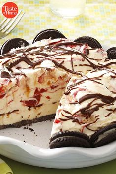 a large piece of cheesecake with chocolate and strawberry toppings on a white plate