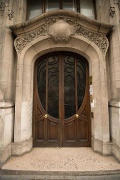 an old building with two large wooden doors