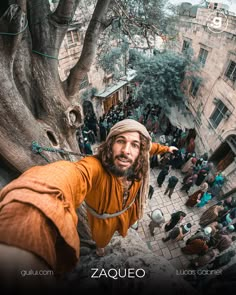 a man with long hair and beard standing in the middle of a courtyard surrounded by people