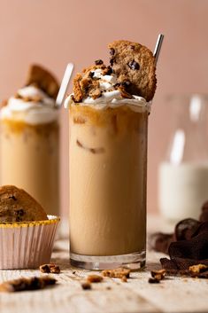 two glasses filled with ice cream and chocolate chip cookies on top of each other next to a muffin