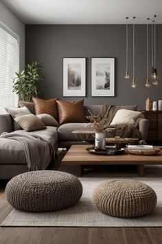 a living room filled with lots of furniture next to a wooden table and two pictures on the wall