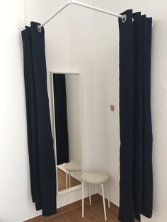 a white chair sitting in front of a mirror