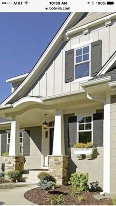 a large house with two garages on the front and side of it, surrounded by landscaping