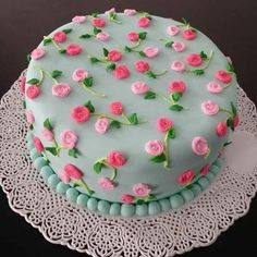 a blue cake with pink roses on it