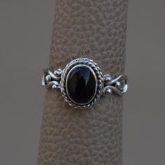 Gemstone-Black Onyx Shape-Oval Metal-925 Sterling Silver This One of a kind ring is adorned with beautiful Black Onyx gemstone in sterling silver.Black Onyx is the birthstone representing the month of December. About gemstone- Black Onyx is the birthstone for Leo. It is the stone of protection.This elegant smooth textured stone is said to have immense healing and spiritual benefits.Black Onyx symbolizes peace,harmony and love and good luck.Black Onyx is well known to remove negativity and act as Black Oval Cabochon Jewelry For Anniversary, Black Sterling Silver Jewelry With Oval Cabochon, Black Oval Cabochon Sterling Silver Jewelry, Black Oval Cabochon Jewelry, Oval Black Cabochon Jewelry, Handmade Oval Onyx Rings, Handmade Oval Onyx Jewelry, Handmade Black Oval Jewelry, Remove Negativity