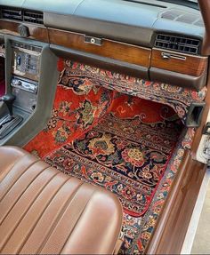 the interior of an old car with carpet and leather seat covers on it's floor