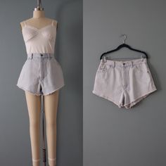 "vintage iconic street style high rise cut off fringed denim shorts in pale washed blue. zipper and button closure, four pockets, leather Lee patch. made by Lee in 1990s fits best size medium: 30\" waist 40\" hips 13\" length 13\" rise 2.5\" inseam in excellent condition!" Retro Cutoff Shorts For Spring, Vintage High-waisted Jean Shorts For Spring, Spring Retro Cutoff Shorts, Retro Spring Jean Shorts With Frayed Hem, Vintage Light Wash Shorts For Summer, 90s High Rise Shorts For Summer, 90s High Rise Summer Shorts, 90s Style High Rise Summer Shorts, Vintage Light Wash Summer Shorts