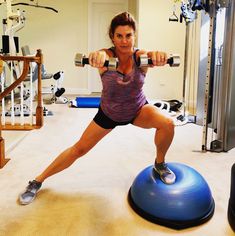 a woman is doing exercises on an exercise ball