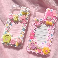 two cell phones with hello kitty decorations on them