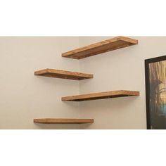 three wooden shelves mounted to the wall