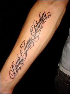 a person with a tattoo on their arm that says believe, love and victory in cursive writing