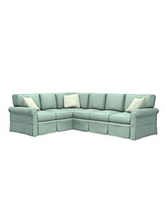 a blue sectional couch with pillows on it's back and side facing each other