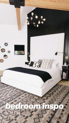 a large white bed sitting in a bedroom on top of a rug