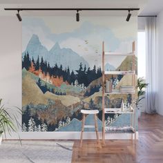 a wall mural with mountains and trees on it