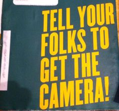 there is a sign that says tell your folks to get the camera