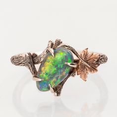 "A handmade 14k twig and leaf ring made in two gold colors and set with a high quality Australian opal. The opal pictured in the ring is a 100% natural Australian black opal weighing 1.7ct The grooves in the band are plated with black rhodium which emphasizes the texture. The ring can also be made with one of the available opals from the loose opals image -  Opal 1 - Dimensions 6.3X11.5X3.1 Weight 1.4ct Price - 2300$ Opal 2 - Dimensions 8.6X5.9X2.8 Weight 0.86ct Price - 2500$ Opal 3 - Dimensions 5.7X8.6X3.5 Weight 0.95ct Price - 2800$ Opal 4 - Dimensions 5.2X8.9X3.1 Weight 0.87ct Price - 3200$ SOLD Opal 5 - Dimensions 9.8X6.7X3.7 Weight 1.7ct Price - 3500$ SOLD Opal 6 - Dimensions 6X8X2.1 Weight 0.61ct Price - 2600$ Opal 7 - Dimensions 5.9X8.6X3.3 Weight 1.11ct Price - 2500$ Opal 8 - Dimen Nature-inspired Opal Ring Gift, Rose Gold Opal Ring, Canary Diamond, Australian Black Opal, Leaf Engagement Ring, Platinum Rose Gold, White Gold Wedding Bands, Rose Gold Wedding Bands, Leaf Ring