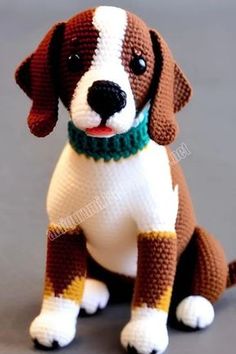 a brown and white dog sitting on top of a gray floor next to a green collar