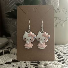 - Adorable Earrings Featuring Hello Kitty - Handmade (By Myself) And Packaged With An Earring Card, Wrapped In A Cellophane Bagperfect For Gifts - Earring Cards Are 6cm (Width) And 9cm (Length) For Size Reference - Charms Are Made Of Resin - These Are Pretty Lightweight - On Silver Fishhook Earring Hooks Colors Are White, Blue, Pink/White Polka Dot Check Out My Closet For More Handmade Jewelry And Other Characters, Including Sanrio Characters Tags: Animal, Forest, Cottagecore, Fairytale, Bear, T Cute White Hello Kitty Jewelry, Cute White Cat Ears Jewelry, Cute Handmade Cat Ears Jewelry, Trendy White Jewelry With Cute Design, Cute White Jewelry With Cat Design, White Cat Design Earrings, Cute White Cat Design Jewelry, Forest Cottagecore, Kawaii Hello Kitty