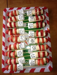 some food is on a plate with toothpicks in the shape of skulls and crossbones