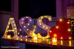 lighted letters that spell out the word as & s are sitting on a counter top