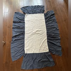 an unmade sleeping bag sitting on the floor in front of a hardwood flooring area