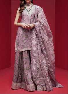 "Material: High-quality Raw silk This ensemble features a pink shirt that exudes grace and elegance, with captivating patterns created by intricate embroidery and shimmering sequin embellishments. It is paired with a modern sharara, beautifully contrasted, and adorned with floral prints. To complete the formal look, there is a classic dupatta elegantly draped, showcasing dazzling floral embroidery. Color : purple/Levander Occasion: Ideal for weddings, parties, or cultural events Ready to wear, no hassle of stitching Comfortable and easy to move in Exquisite craftsmanship Care Instructions: Dry clean only for long-lasting beauty and durability  the color of the product in the photo might look slightly different in person due to factors like lighting and screen settings.\"	in stock	175.00 US Pink Chanderi Dress With Intricate Embroidery, Pink Dola Silk Sharara For Designer Wear, Pink Dola Silk Sharara For Designer Occasions, Designer Pink Dola Silk Sharara, Pink Dola Silk Sharara With Resham Embroidery, Pink Dola Silk Palazzo Set For Diwali, Pink Resham Embroidery Sharara In Dola Silk, Pink Palazzo Set With Intricate Embroidery For Wedding, Wedding Palazzo Set In Pink With Intricate Embroidery