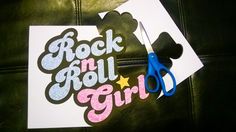 the rock and roll girl sticker is on top of a piece of paper with scissors