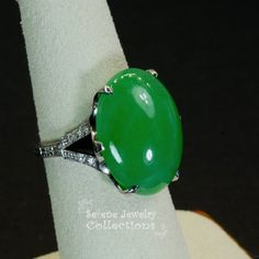 This Art Deco Antique Platinum Diamond Ring has a large juicy green jadeite cabochon as its center piece and has a delicate diamond studded band! Ring Size: 5.5Total Weight: 9.36 gramsPrecious Metal: Platinum Precious stones:-Jadeite Untreated (A jade) Center Stone: 14 carats, 19mm x 13mm-White Round Diamonds: 0.12 caratsHallmark: Yes, but Worn out, can't decipher Oval Green Diamond Gemstones, Exquisite Oval Jade Jewelry, Elegant Emerald Jade Ring With Cabochon, Fine Jewelry Green Oval Cabochon, Elegant Oval Cabochon Jade Jewelry, Exquisite Green Cabochon Jewelry, Formal Cabochon Chrysoprase Jewelry, Fine Jewelry: Jade Cabochon, Fine Jade Jewelry With Cabochon