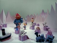 a group of toy figurines sitting on top of snow covered ground