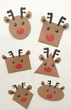 four reindeer faces cut out from cardboard on a white surface