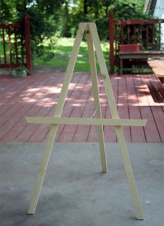 a wooden easel sitting on top of a patio