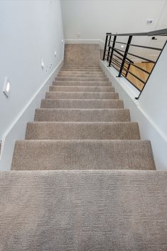 the carpeted stairs lead up to the second floor