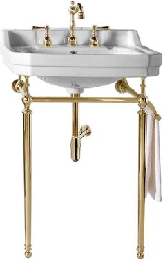 a bathroom sink with two faucets on the side and gold fixtures around it