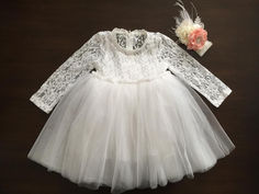 A soft white ballerina baptism dress with floral headband Elegant White Tutu Dress For Confirmation, Elegant Spring Tutu Dress For Confirmation, Spring First Communion Fitted Lace Dress, Spring First Communion Lace Dress, Elegant Tutu Dress With Lace Bodice For Confirmation, Spring Lace Dress For First Communion, Fitted Lace Dress For First Communion In Spring, Fitted Lace Bodice Tutu Dress, Spring Fitted Lace Dress For First Communion