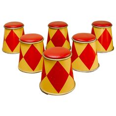 four red and yellow canisters sitting next to each other