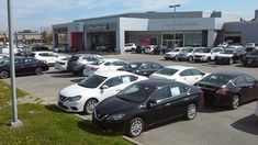 a parking lot full of cars in front of a building