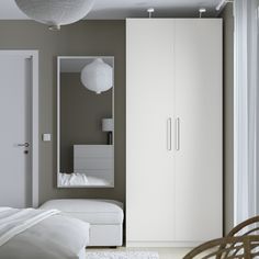 a bedroom with a bed, closet and white furniture in it's center area