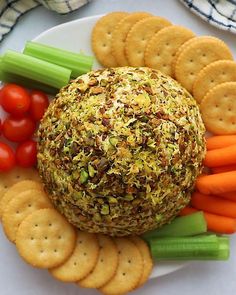 a white plate topped with crackers and vegetables