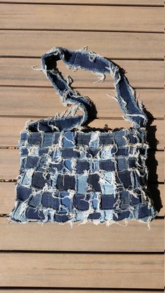 an old handbag that has been torn and is sitting on a wooden floor