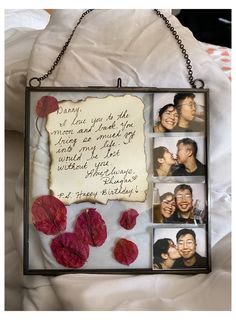 a photo frame with four photos and a message attached to it, hanging on a chain