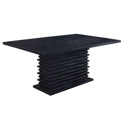 a stack of black plates sitting on top of each other in front of a white background