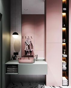 a bathroom with pink walls and marble flooring, along with white towels on the shelf