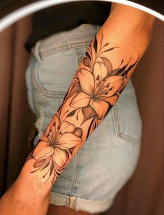 a woman's arm with flowers on it