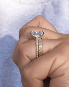 a person holding a diamond ring in their hand