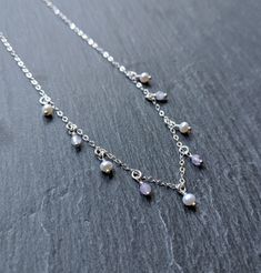 "\"Oprah\" ♀️ Sterling silver chain necklace with pearls and amethyst beads ♀️ Amethyst keywords: Sobriety and Psychic ♀️ Pearl keywords: Innocence and Generosity ♀️ Nickel free ♀️ Model is wearing 16 in. necklace \"Think like a queen. A queen is not afraid to fail. Failure is another steppingstone to greatness.\" Oprah Winfrey" Silver Birthstone Drop Necklace, Silver Amethyst Dangle Necklaces, Silver Drop Necklace With Birthstone, Silver Amethyst Dangle Necklace, Silver Amethyst Necklace For Wedding, Silver Amethyst Briolette Necklace, Dainty Silver Charm Necklaces With Pearl Drop, Silver Dangle Necklaces With Pearl Drop, Dainty Silver Charm Necklace With Pearl Drop