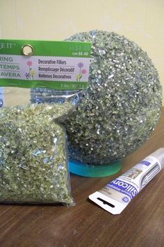 two bags of silver glitter sitting on top of a table next to a tube of toothpaste