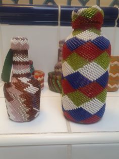 three colorful vases sitting on top of a white counter